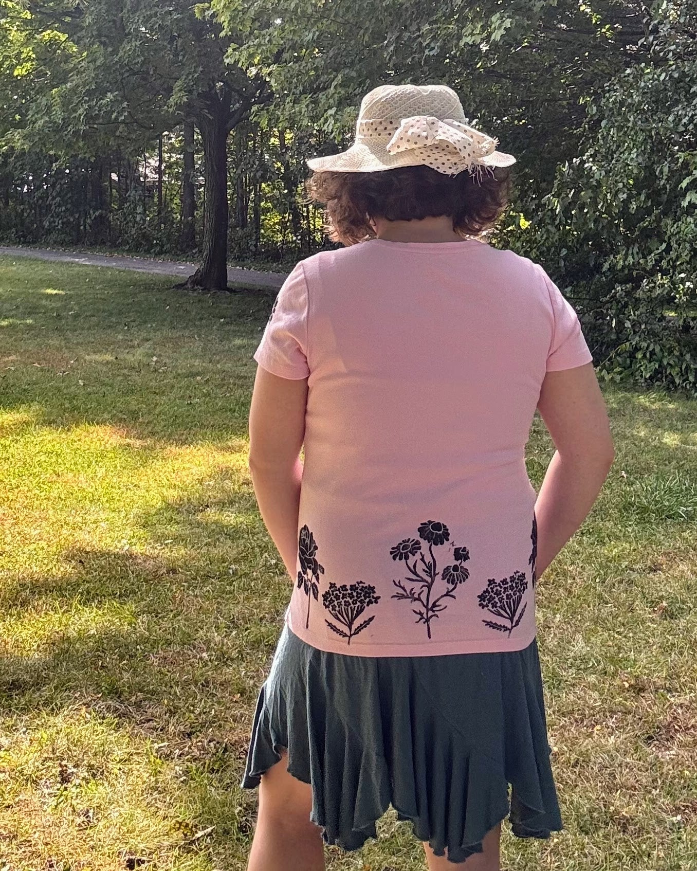 Free & Wild; pink short sleeve t-shirt featuring roses and wildflowers