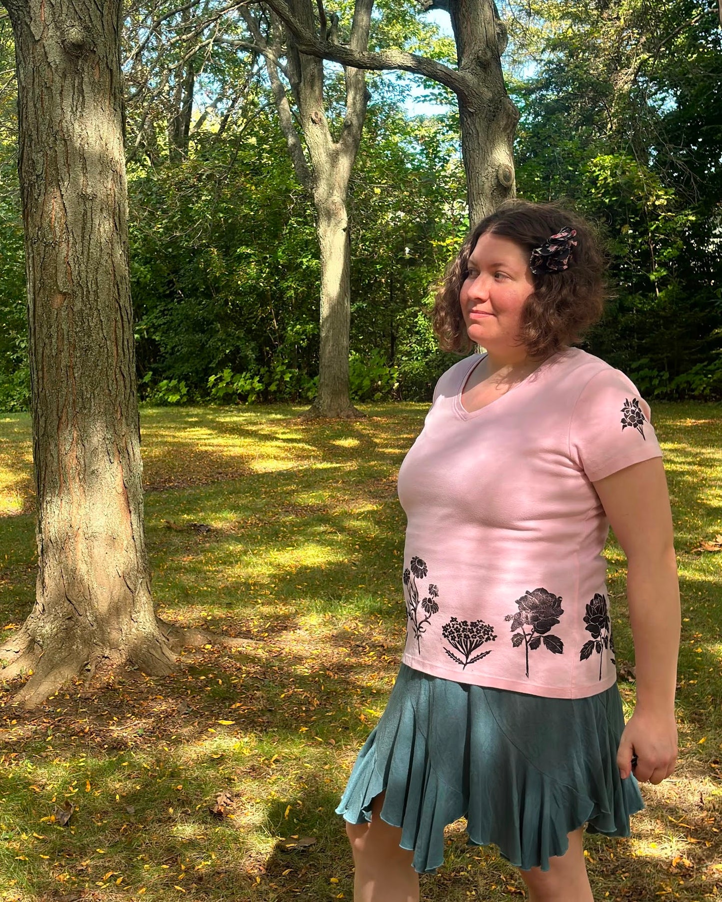 Free & Wild; pink short sleeve t-shirt featuring roses and wildflowers