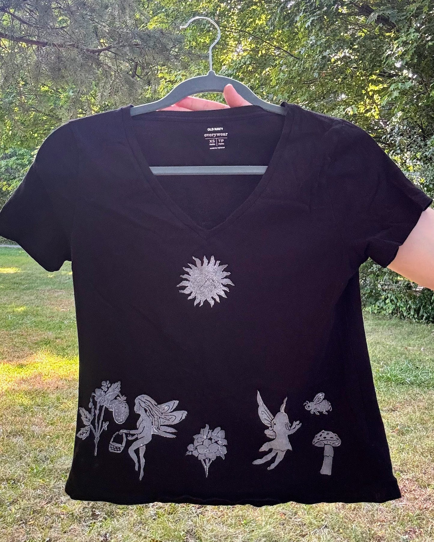 Frolicking Fairies; black t-shirt featuring fairies and wildflowers