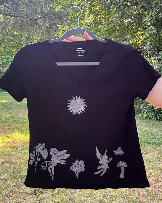 Frolicking Fairies; black t-shirt featuring fairies and wildflowers